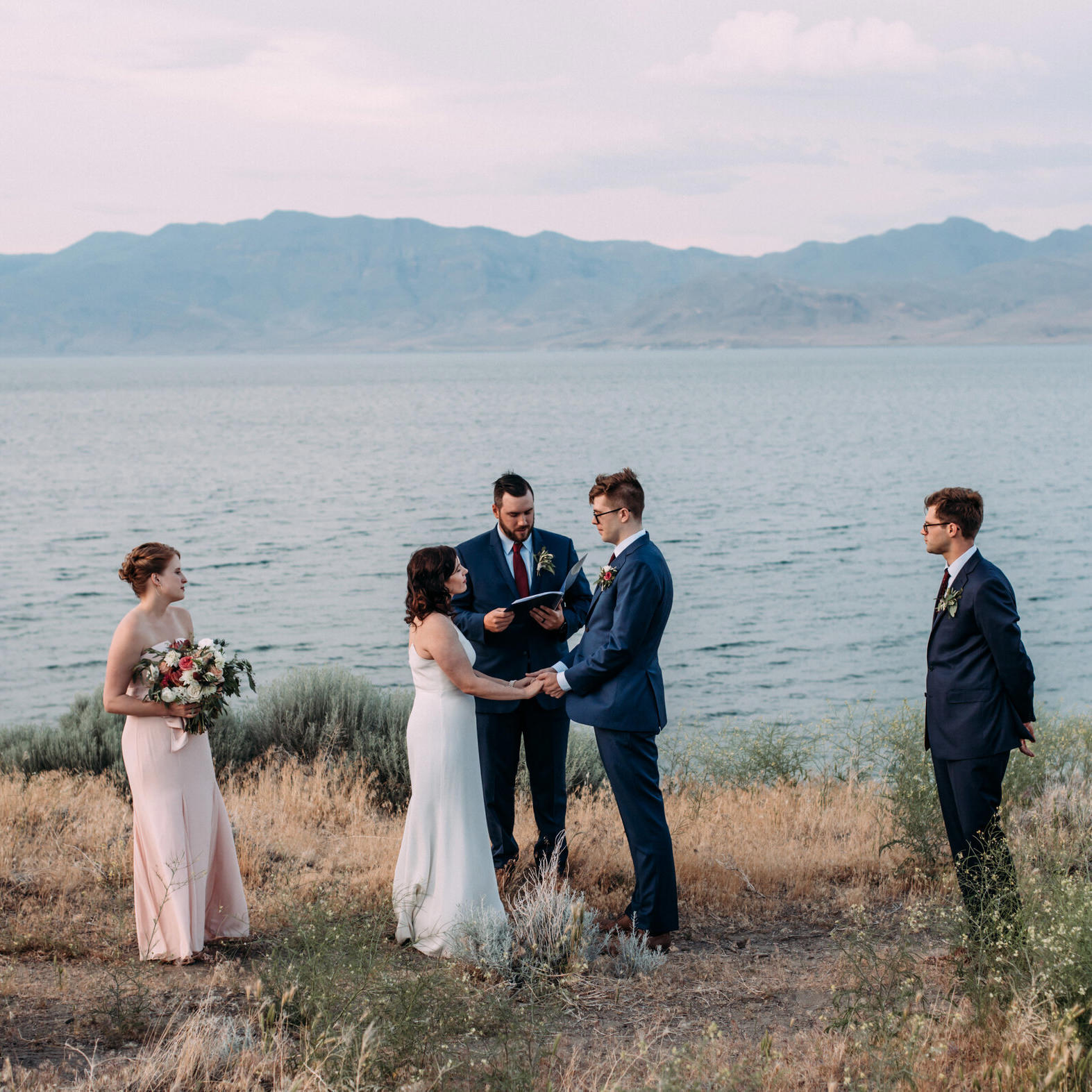 couple getting married outdoors by lake