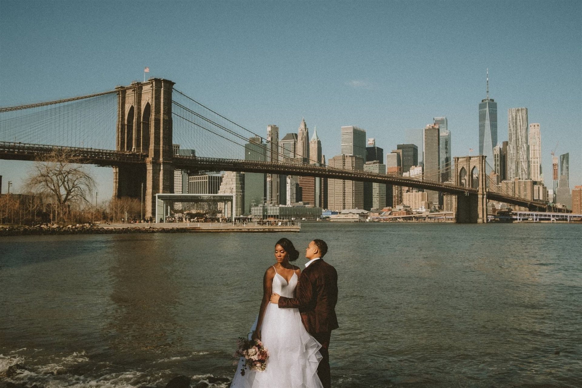 married lesbian couple by bridge in nyc