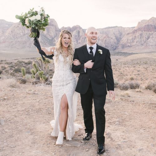 happy couple walking in the desert to get married