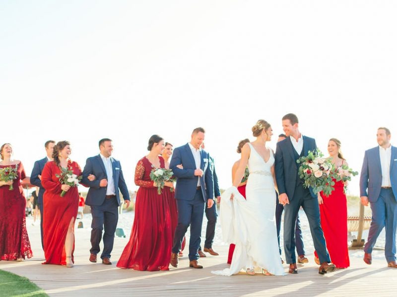 bridal party with bride and groom walking