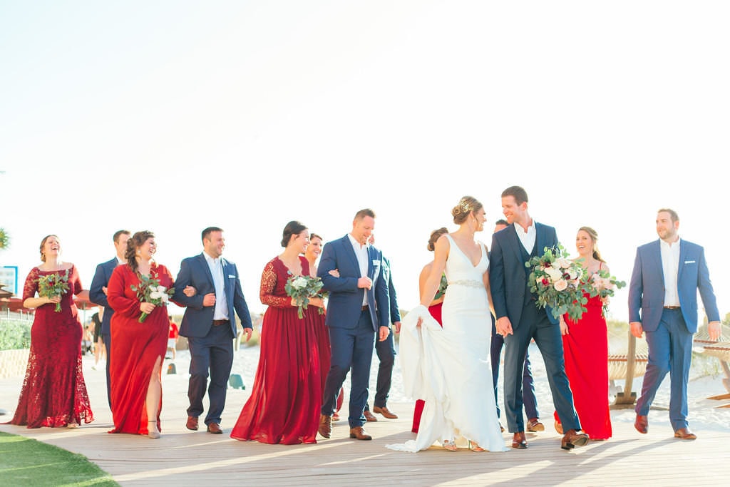 bridal party with bride and groom walking