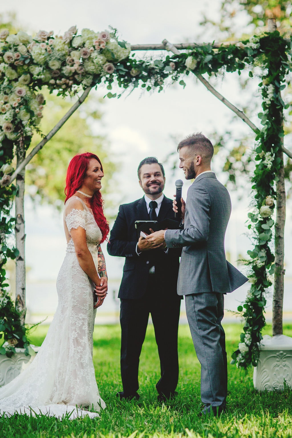 gorgeous smiling bridge and handsome groom saying vows