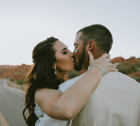 couple kissing after desert elopement ceremony