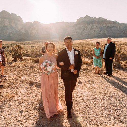 stunning woman at wedding with sunsetting in desert