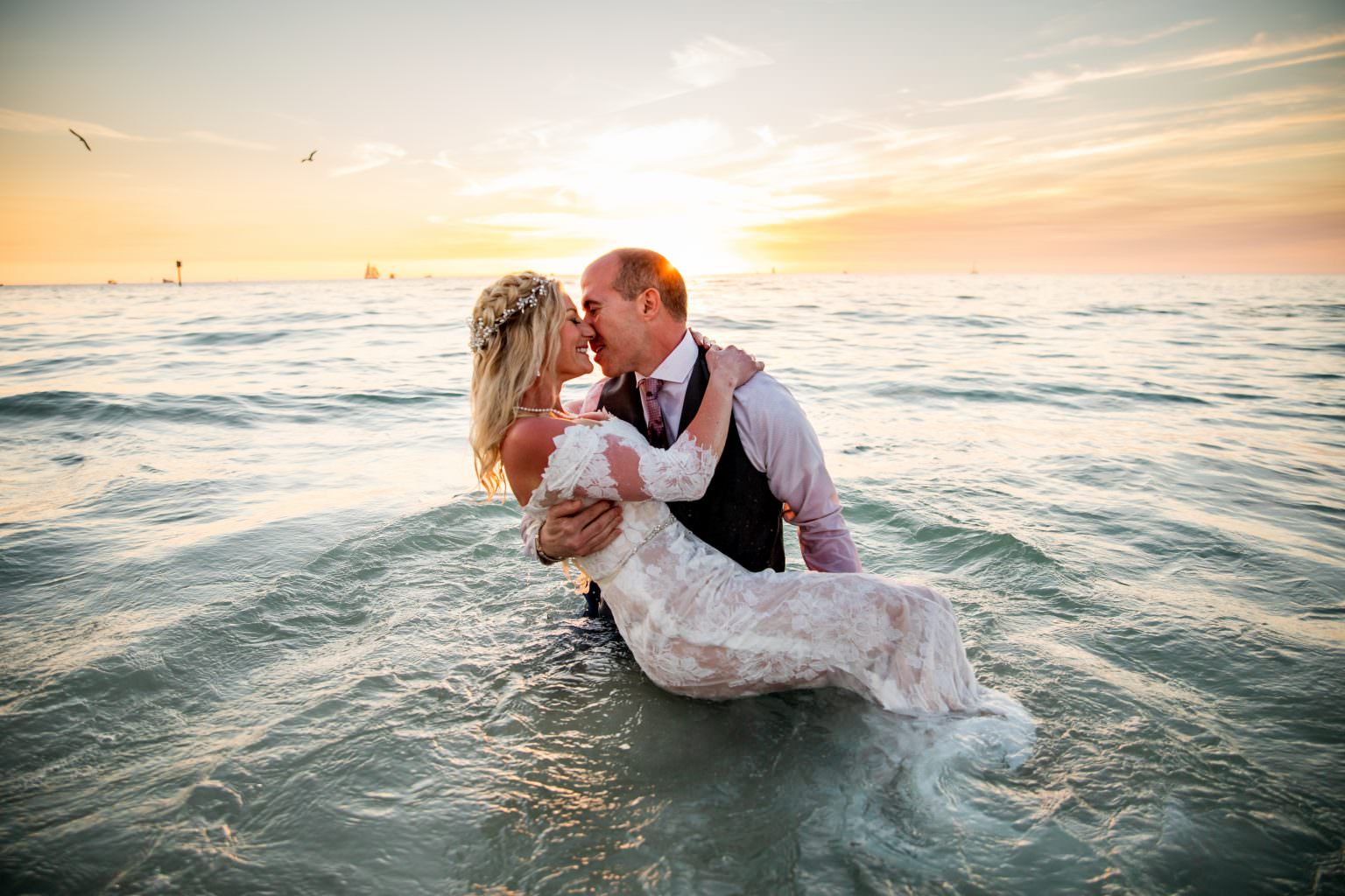 couple kissing in the water after eloping