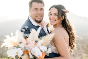 bride and groom with beautiful floral bouquet