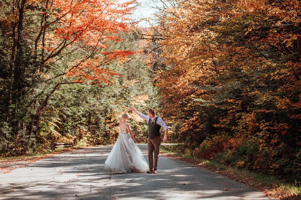 couple eloping in fall in stowe vt with leaves changing color