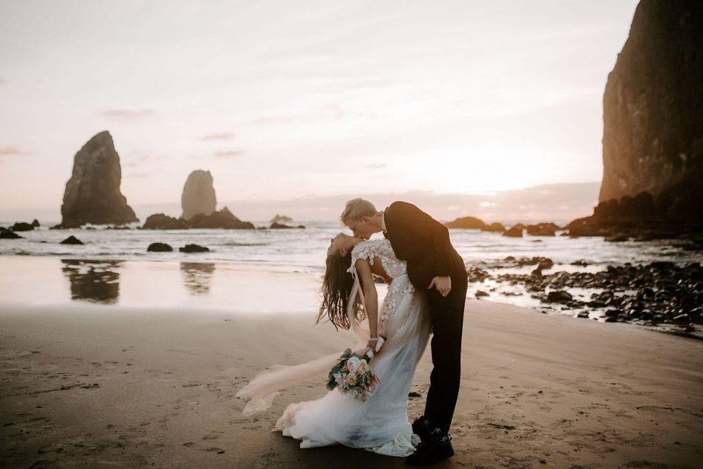 cannon beach wedding picture of couple by ocean in oregon
