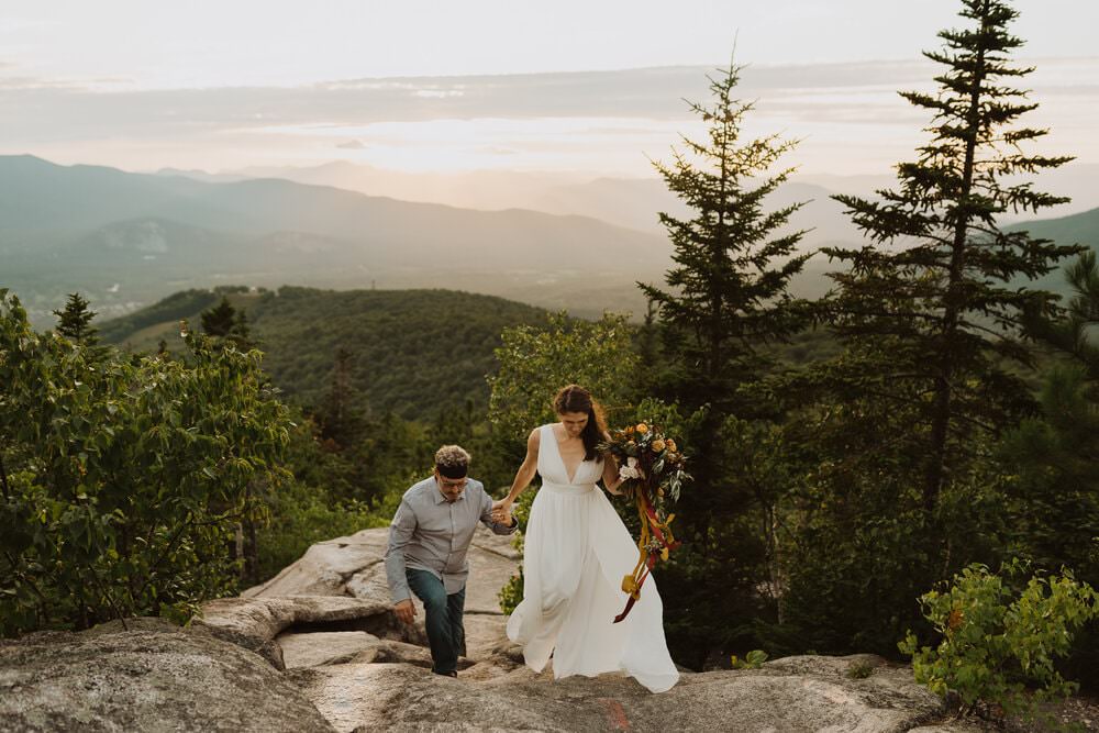 couple hiking to their wedding location in white mountains nh