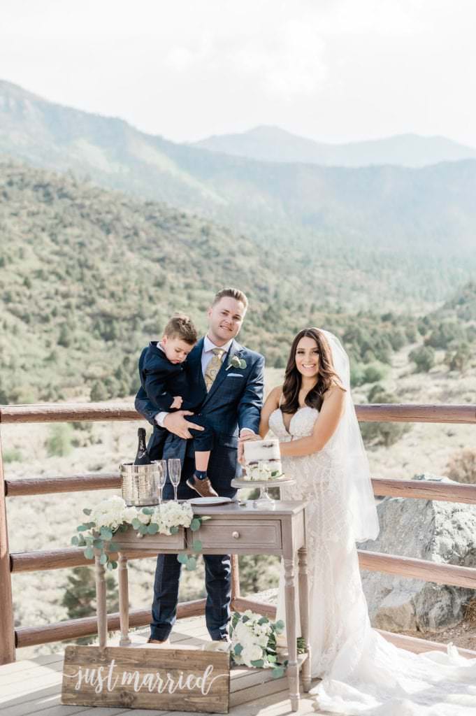 couple just married at outdoor wedding with child