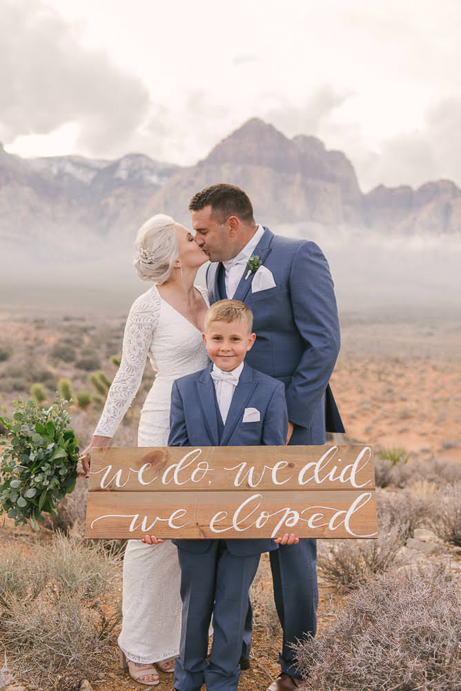 couple after elopement with son with mountain backdrop