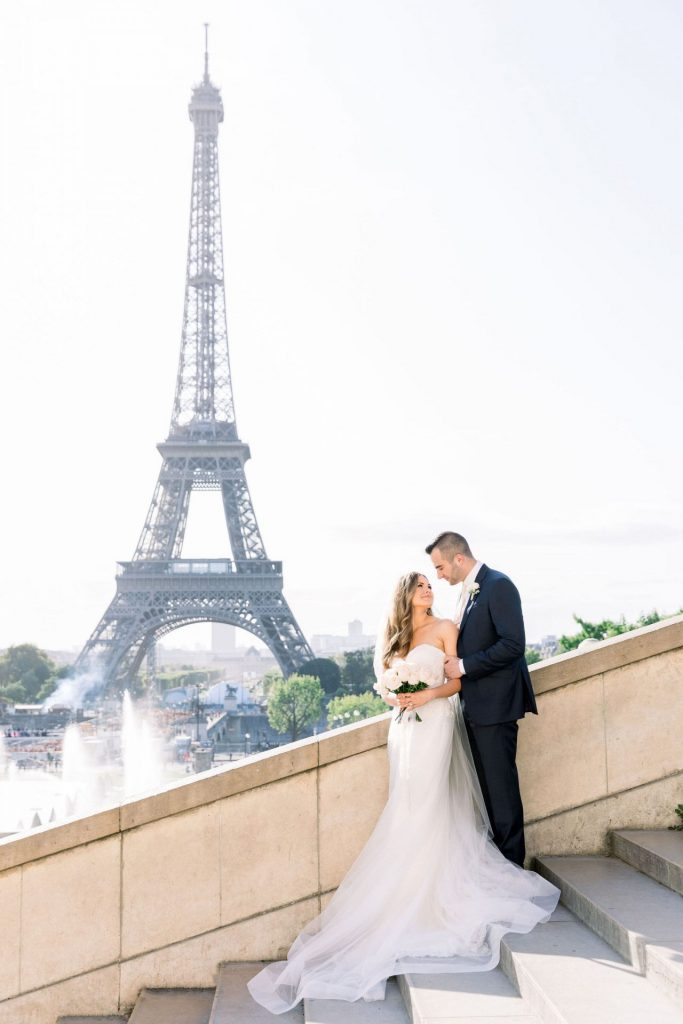 couple eloping with the Eiffel tower behind them