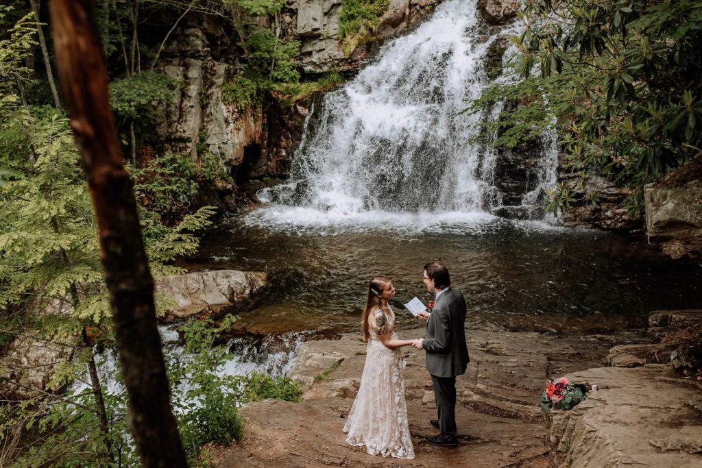 pocono mountain wedding picture of couple by waterfall