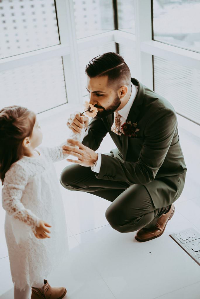 father and young female child doing first look for wedding