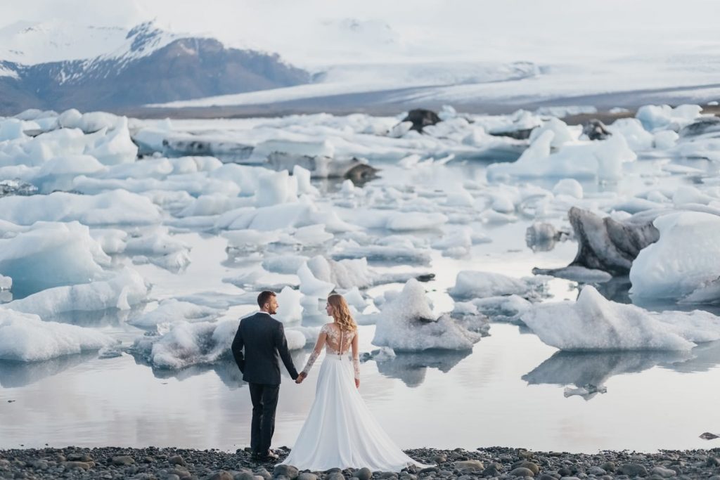Couple eloping in glacier lagoon, iceland