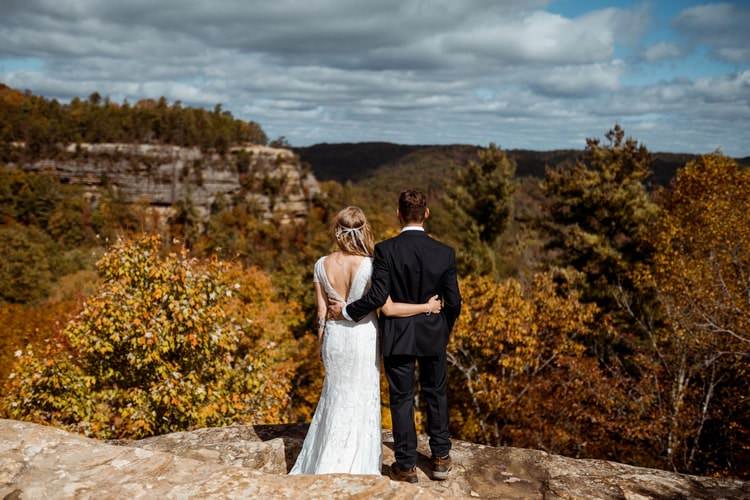 couple facing trees and mountains in elopement photo