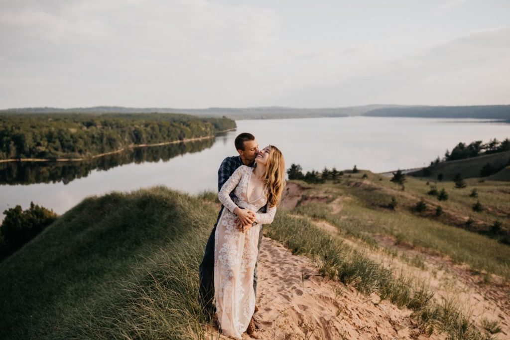 couple taking elopement photos in michigan at pictured rocks national lakeshore