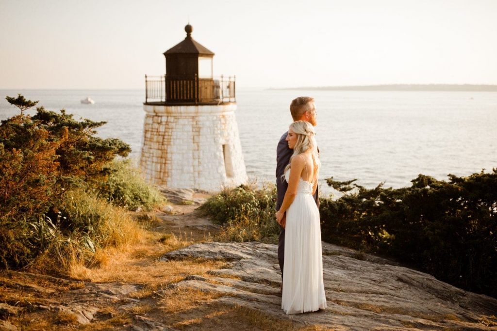 couple by lighthouse in newport rhode island for elopement photos