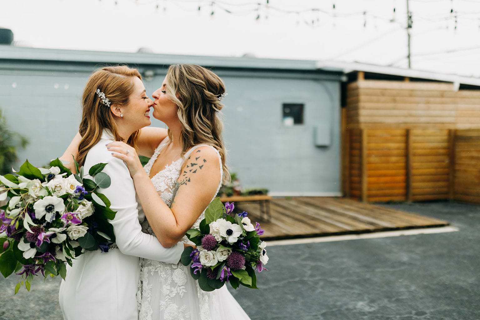 two brides kissing at lgbt wedding