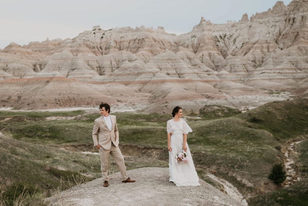 couple taking elopement photo in badlands national park